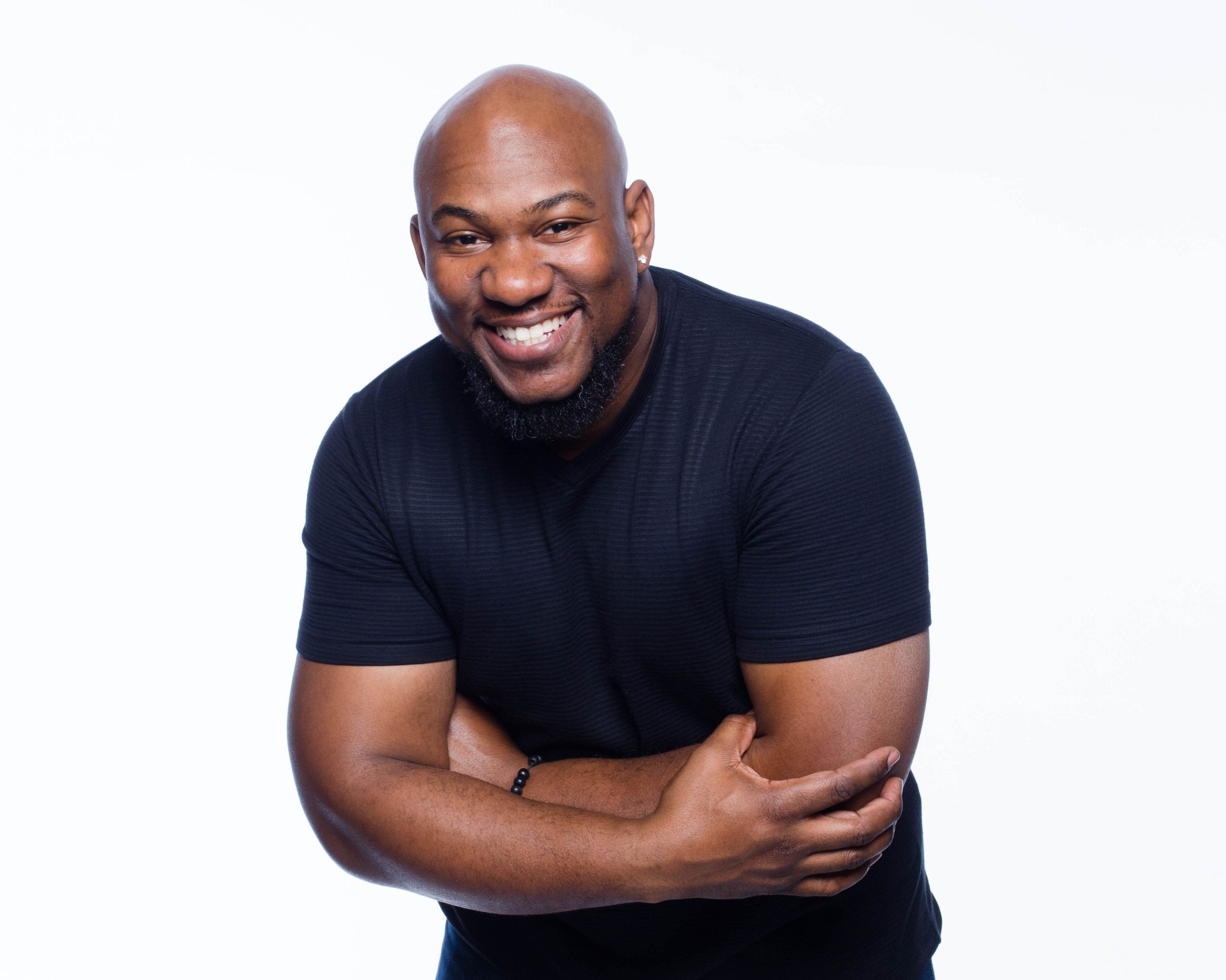 Frankie C. Wilson Jr. smiling with arms crossed